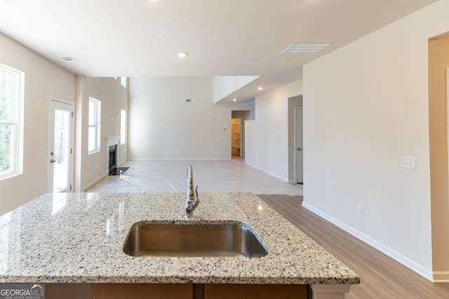 470 River Run Dr Unit 63, Dallas, GA 30132 - kitchen with a sink, open floor plan, a fireplace, light wood finished floors, and recessed lighting