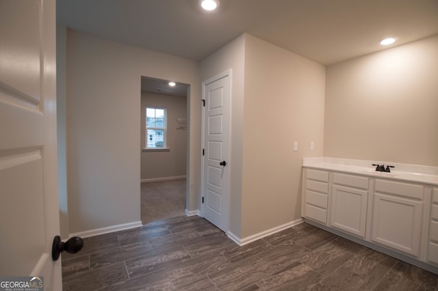 interior space with vanity and wood-type flooring