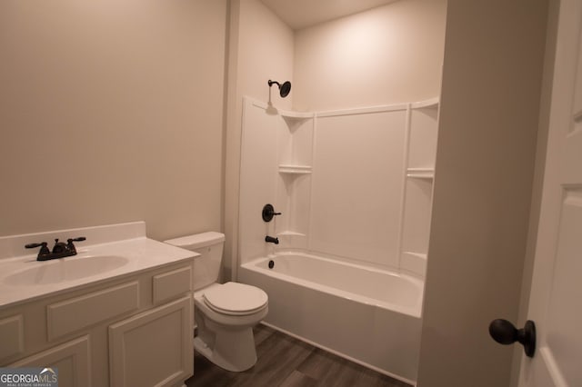 full bathroom featuring toilet, hardwood / wood-style flooring, vanity, and bathing tub / shower combination