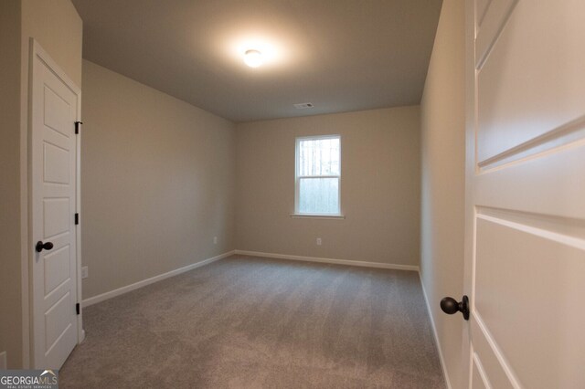 unfurnished room with carpet floors