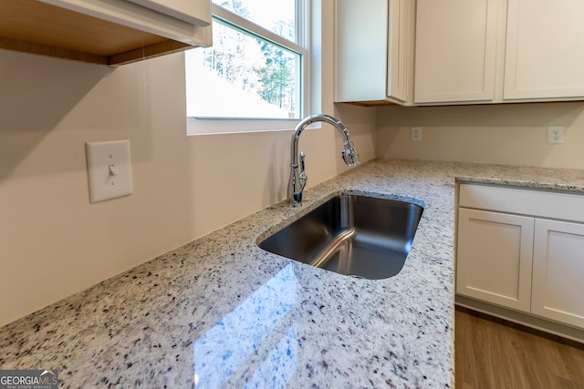 530 River Run Dr Unit 58, Dallas, GA 30132 - kitchen view of a sink, light stone countertops, and white cabinetry