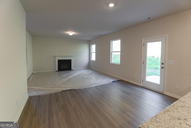 530 River Run Dr Unit 58, Dallas, GA 30132 - unfurnished living room with wood finished floors, baseboards, a fireplace with flush hearth, and recessed lighting