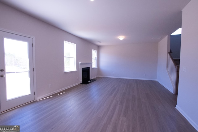 530 River Run Dr Unit 58, Dallas, GA 30132 - unfurnished living room featuring a fireplace, dark wood-type flooring, and baseboards