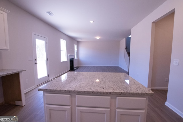 530 River Run Dr Unit 58, Dallas, GA 30132 - kitchen with dark wood-style floors, a fireplace with flush hearth, a center island, white cabinetry, and recessed lighting
