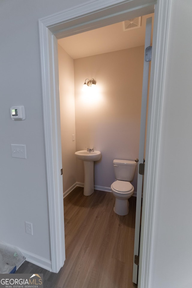 530 River Run Dr Unit 58, Dallas, GA 30132 - half bath with baseboards, wood finished floors, toilet, and a sink