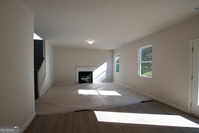 530 River Run Dr Unit 58, Dallas, GA 30132 - unfurnished living room with wood finished floors, baseboards, and a fireplace with flush hearth