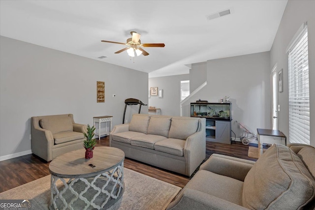 living room with dark hardwood / wood-style flooring and ceiling fan