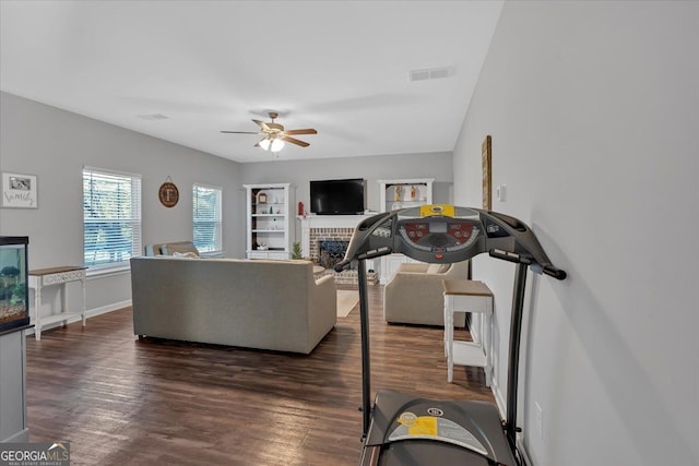 living room with ceiling fan, dark hardwood / wood-style flooring, and a fireplace