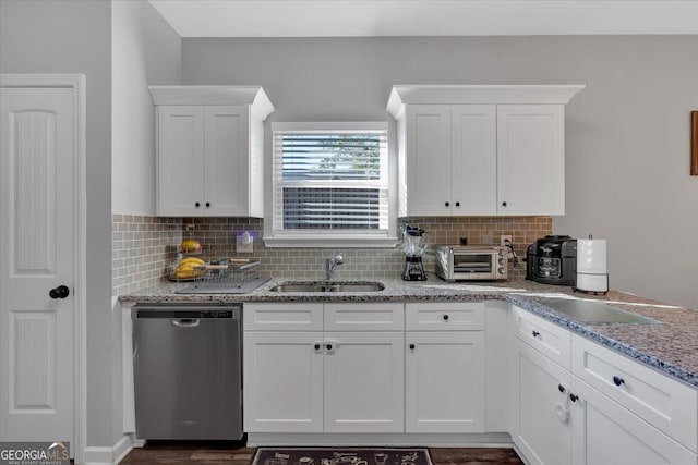 kitchen with dishwasher, decorative backsplash, white cabinetry, and sink