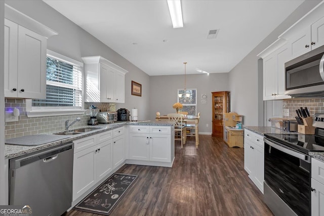 kitchen featuring kitchen peninsula, white cabinetry, sink, and stainless steel appliances