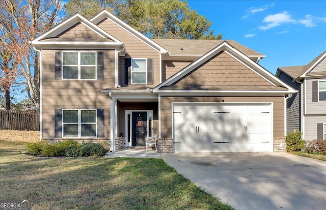 craftsman-style home featuring a front yard and a garage