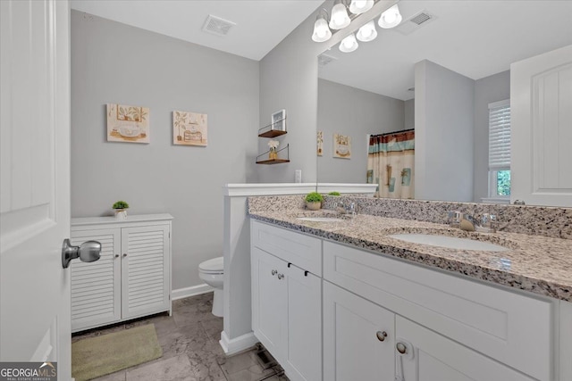 bathroom featuring vanity and toilet