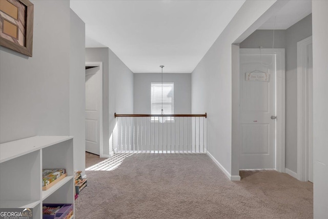 hall with light colored carpet