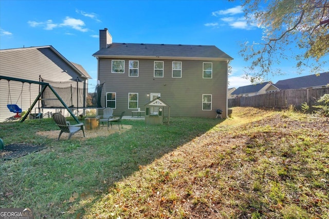 back of house featuring a lawn