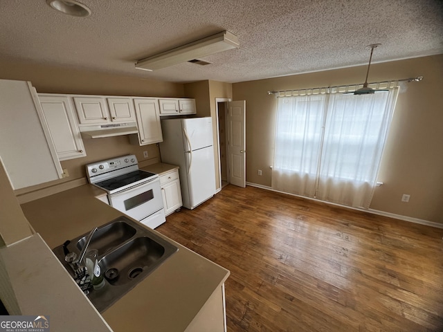 kitchen featuring white cabinetry, dark hardwood / wood-style flooring, hanging light fixtures, and white appliances