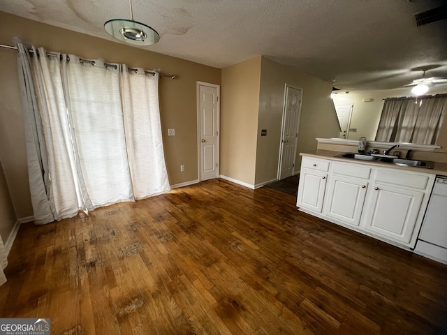 kitchen featuring white cabinetry, a textured ceiling, sink, dark wood-type flooring, and ceiling fan