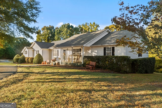 ranch-style home featuring a porch and a front yard