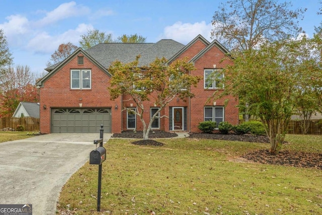 view of front of house with a front yard and a garage