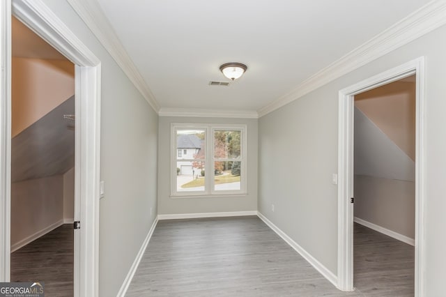 interior space featuring hardwood / wood-style floors and crown molding