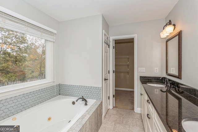 bathroom with vanity and tiled bath