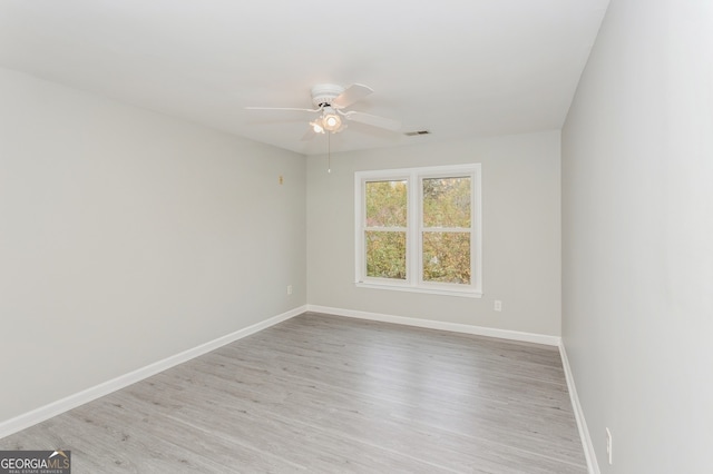 spare room with light hardwood / wood-style floors and ceiling fan