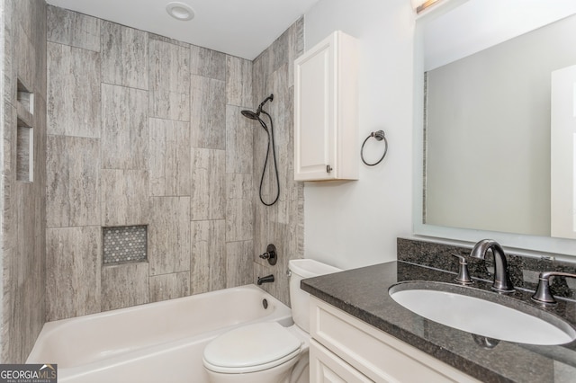 full bathroom featuring toilet, tiled shower / bath, and vanity