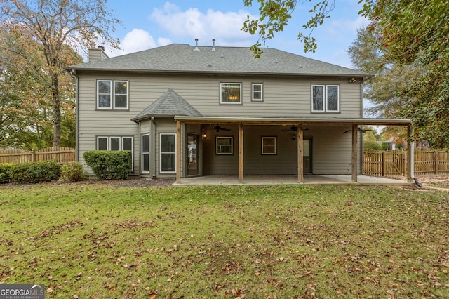 back of house with a patio and a yard