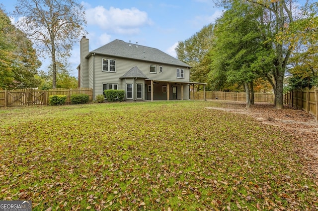 back of property featuring a yard and a patio area