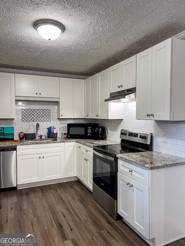 kitchen with appliances with stainless steel finishes, white cabinetry, dark wood-type flooring, and sink