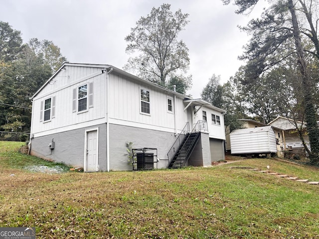 view of front facade with stairs and a front lawn