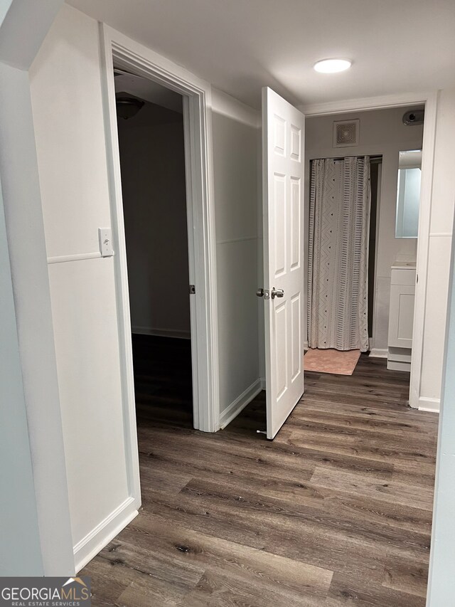 basement with dark hardwood / wood-style flooring