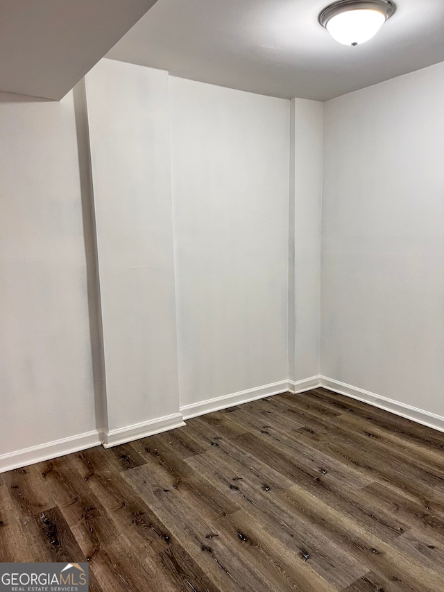 empty room featuring dark hardwood / wood-style flooring