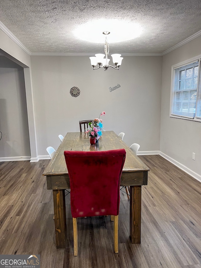 dining area with crown molding, an inviting chandelier, and wood finished floors