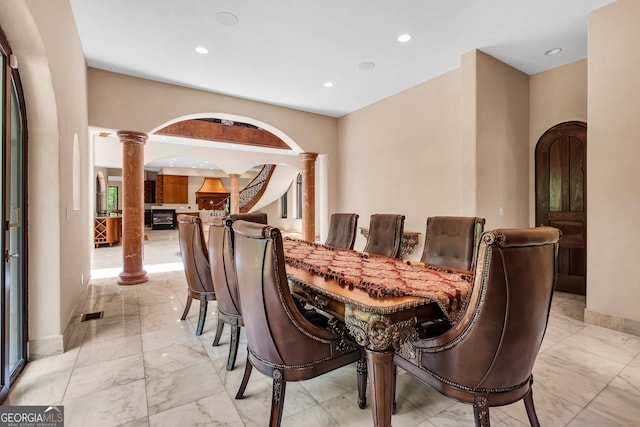 dining area featuring ornate columns