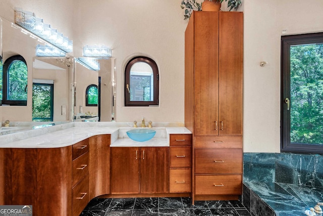 bathroom featuring vanity and a tub to relax in