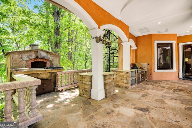 view of patio / terrace with an outdoor fireplace