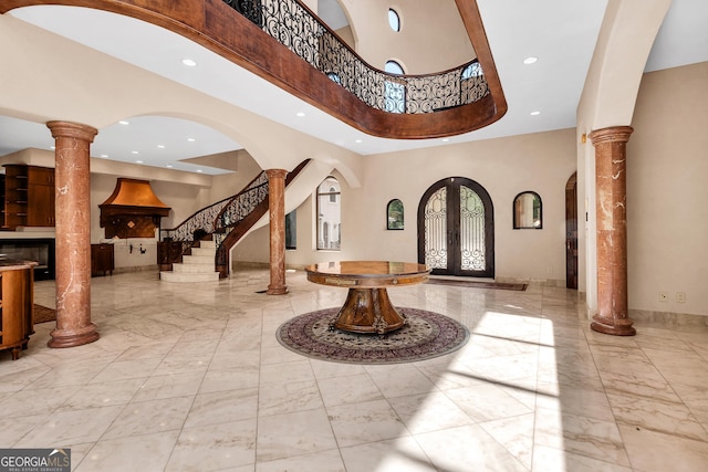 foyer featuring french doors and decorative columns