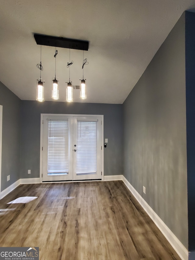 interior space with wood-type flooring and french doors