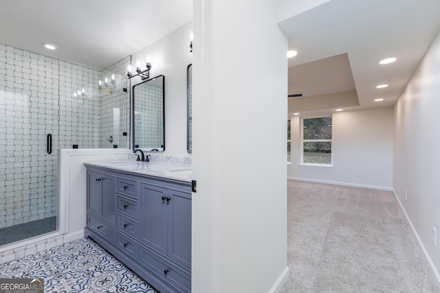 bathroom with vanity and a shower with door