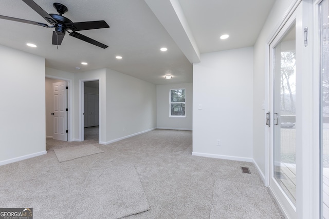 carpeted empty room featuring ceiling fan