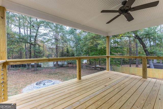 wooden terrace with ceiling fan and an outdoor fire pit