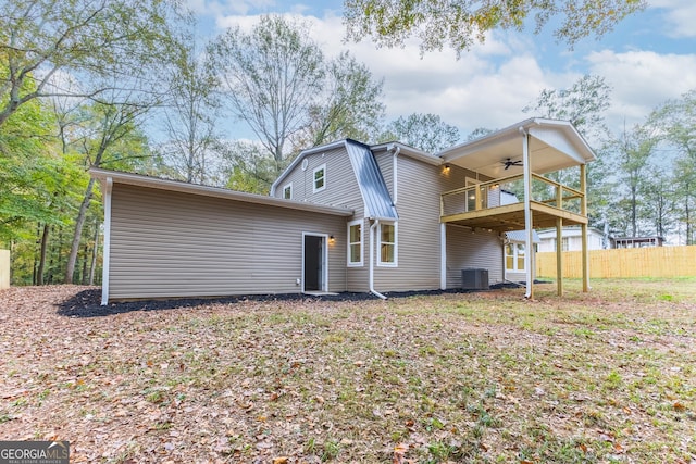 rear view of property featuring ceiling fan, a balcony, and central air condition unit