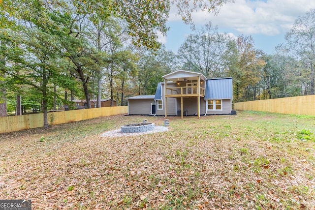 view of yard featuring a balcony and a fire pit