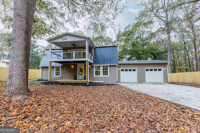 view of front of property with ceiling fan, a balcony, and a garage