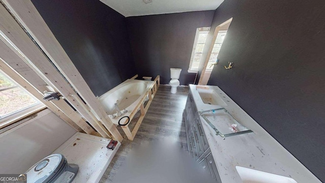 bathroom featuring hardwood / wood-style floors, a bathtub, and toilet