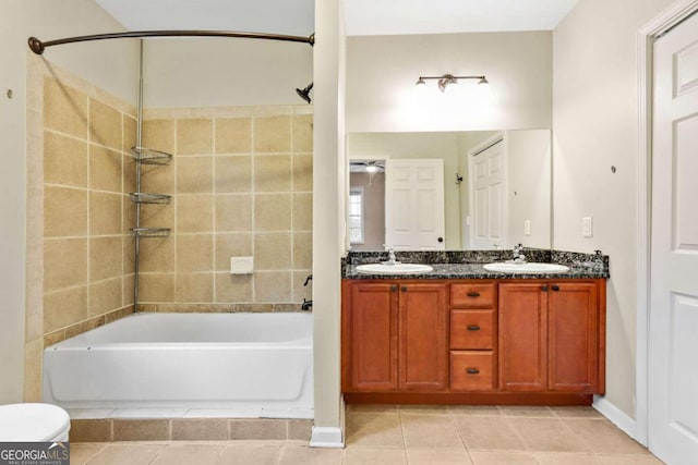 full bathroom with vanity, tiled shower / bath combo, toilet, and tile patterned floors