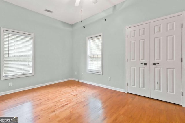 unfurnished bedroom with a closet, ceiling fan, and light hardwood / wood-style floors