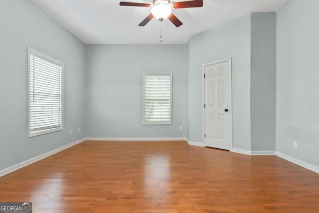 empty room featuring hardwood / wood-style flooring and ceiling fan