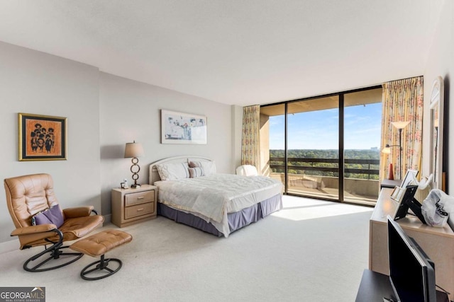 carpeted bedroom with access to exterior and a wall of windows