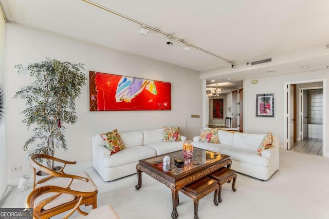 living room featuring carpet and a notable chandelier